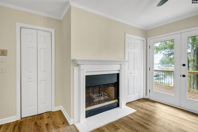 unfurnished living room featuring ceiling fan, french doors, light hardwood / wood-style flooring, and crown molding