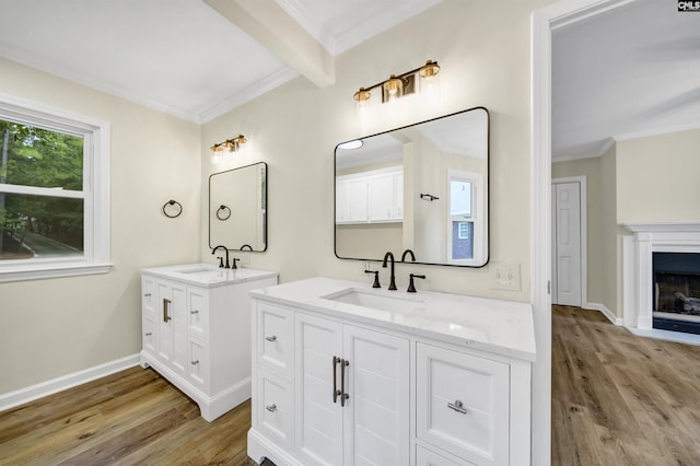 bathroom featuring hardwood / wood-style floors, vanity, ornamental molding, and beamed ceiling