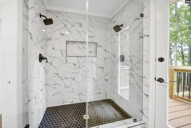 bathroom with walk in shower and ornamental molding