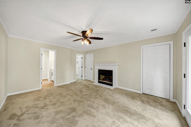 unfurnished living room featuring ornamental molding, ceiling fan, and light colored carpet