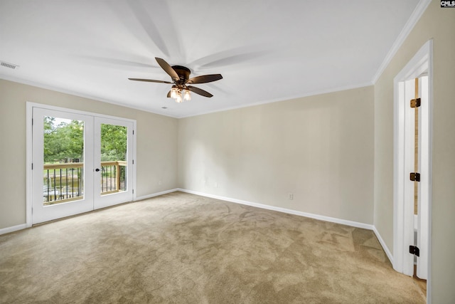 empty room with ceiling fan, french doors, light colored carpet, and ornamental molding