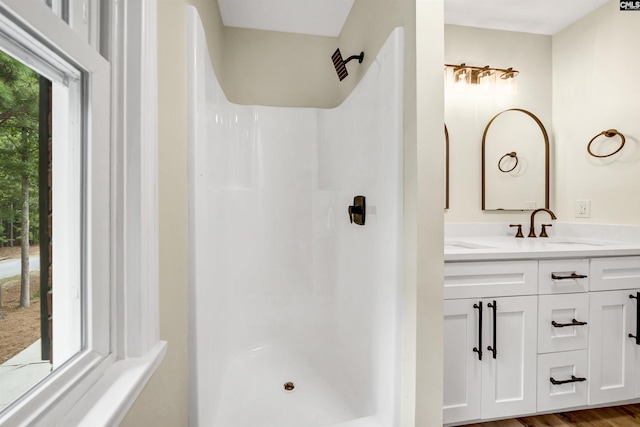 bathroom with vanity, a shower, and hardwood / wood-style floors