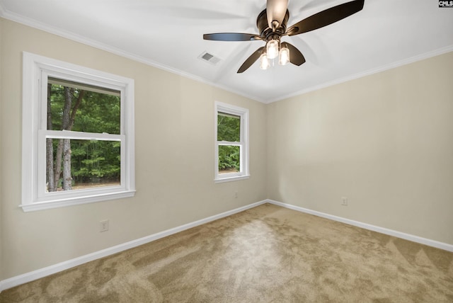 carpeted empty room with ceiling fan and ornamental molding