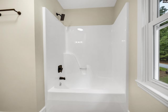 bathroom with bathing tub / shower combination