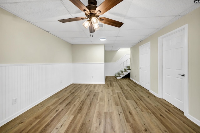 unfurnished room with ceiling fan, a paneled ceiling, and light hardwood / wood-style flooring