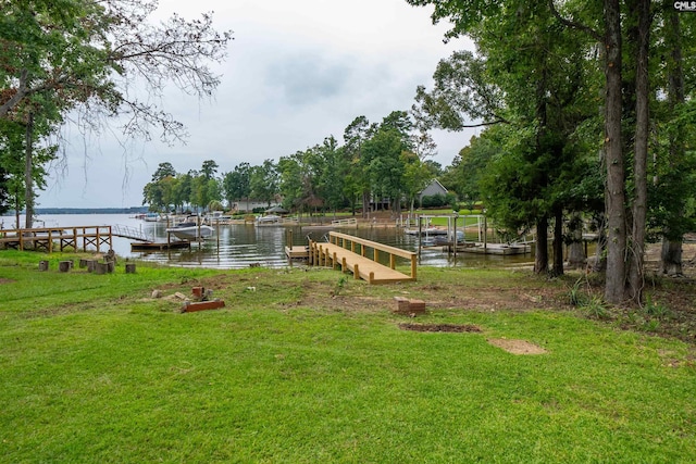 view of yard with a boat dock and a water view