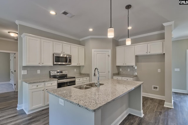 kitchen featuring white cabinetry, stainless steel appliances, and a kitchen island with sink