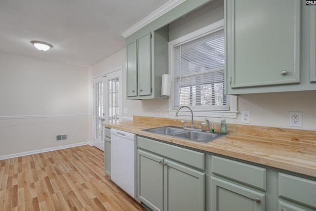 kitchen featuring dishwasher, french doors, sink, butcher block countertops, and light hardwood / wood-style floors