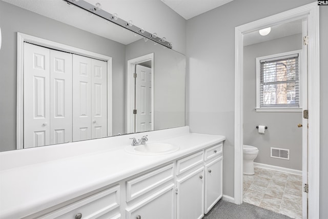 bathroom featuring toilet and vanity