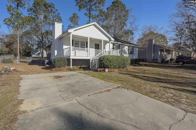 view of front of house with a porch and a front yard