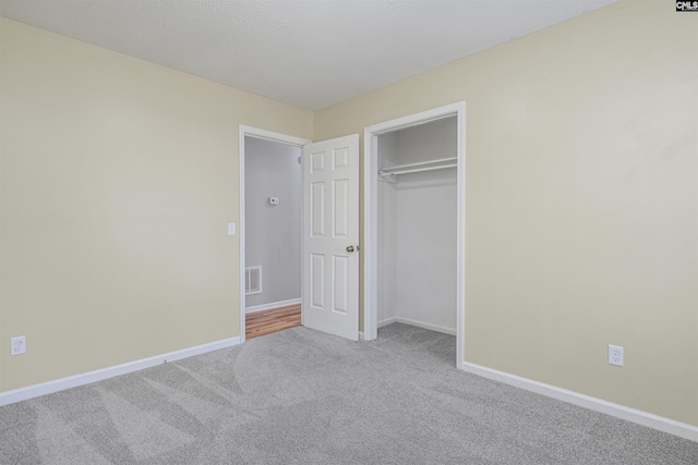 unfurnished bedroom with carpet and a closet