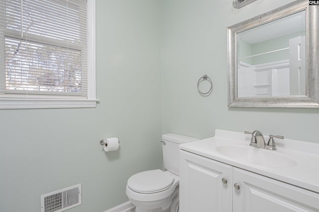 bathroom with vanity, toilet, and walk in shower