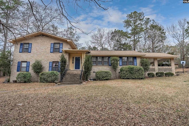 tri-level home with a front yard