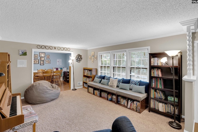 carpeted living room featuring a textured ceiling and crown molding