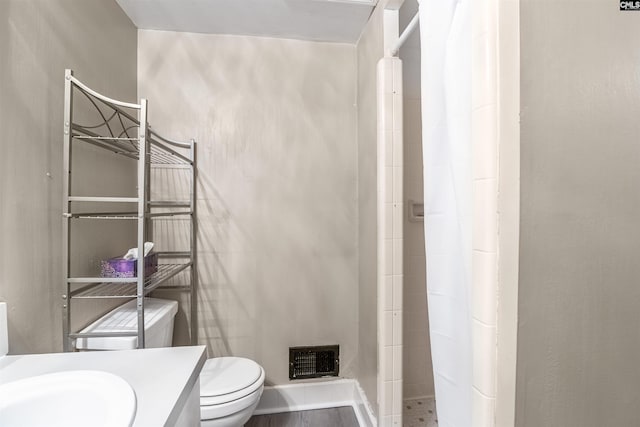 bathroom featuring a shower with curtain, hardwood / wood-style flooring, toilet, and vanity