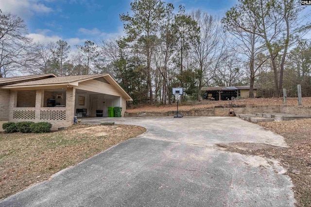 view of yard with a carport and a porch