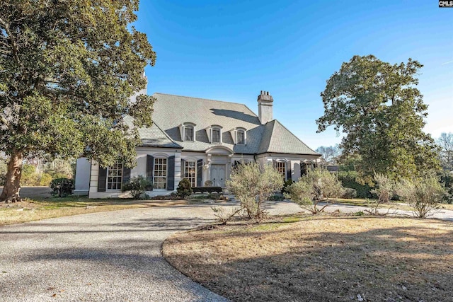 french country home with a front lawn