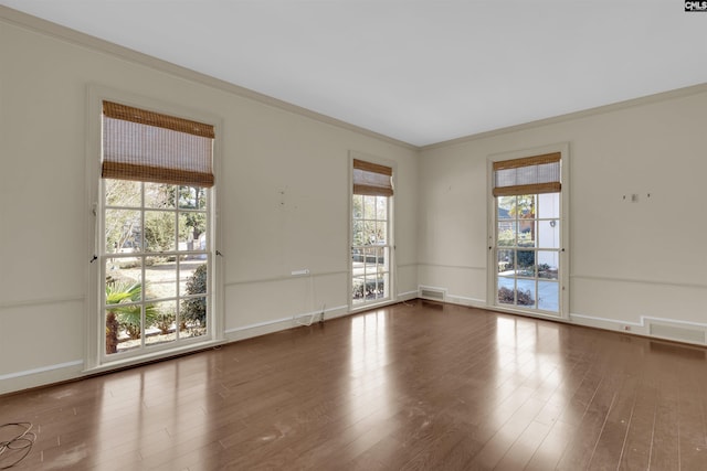 spare room with dark hardwood / wood-style flooring and crown molding