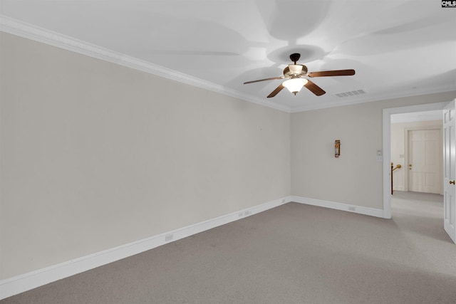 carpeted spare room with ceiling fan and ornamental molding