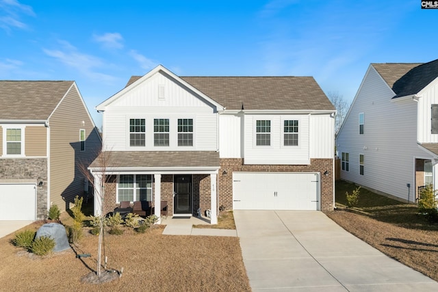 view of front of property with a garage, a front lawn, and covered porch