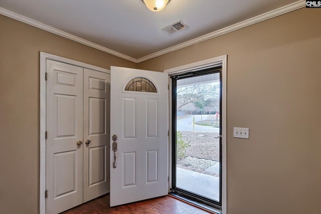 entrance foyer featuring dark hardwood / wood-style flooring and crown molding