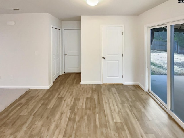 interior space featuring light hardwood / wood-style floors, access to exterior, and a closet