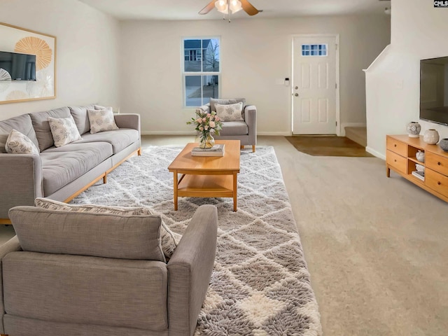 carpeted living room with ceiling fan