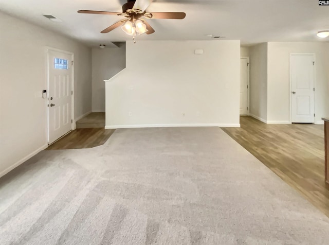 unfurnished living room with carpet flooring and ceiling fan