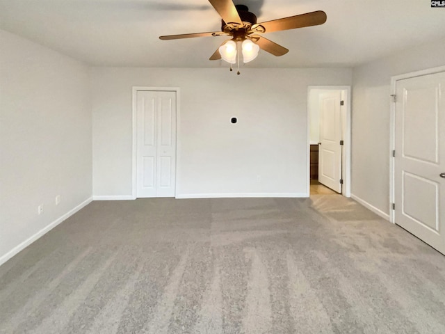 carpeted spare room featuring ceiling fan