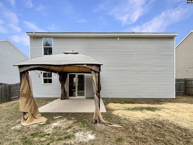 back of house with a gazebo and a patio