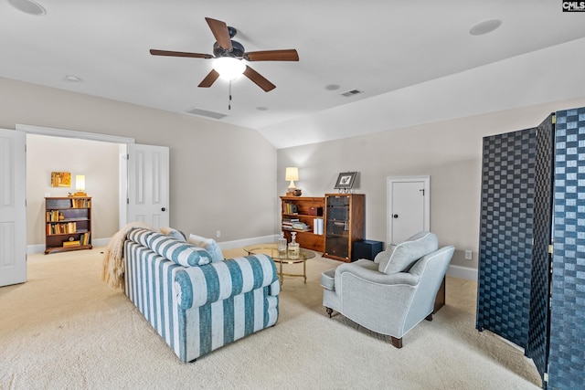 carpeted living room featuring ceiling fan and vaulted ceiling