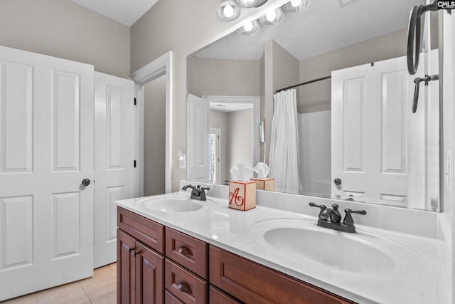 bathroom with curtained shower, vanity, and tile patterned flooring