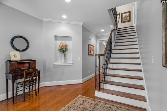 foyer featuring crown molding and wood-type flooring