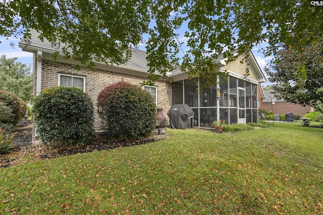 exterior space with a sunroom and a yard