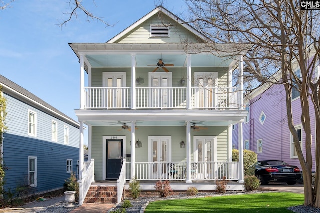 view of front of property featuring a balcony, covered porch, ceiling fan, and french doors