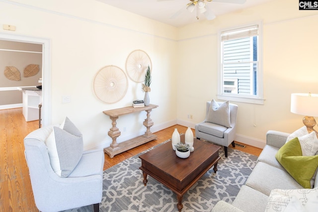 living room featuring ceiling fan and hardwood / wood-style floors