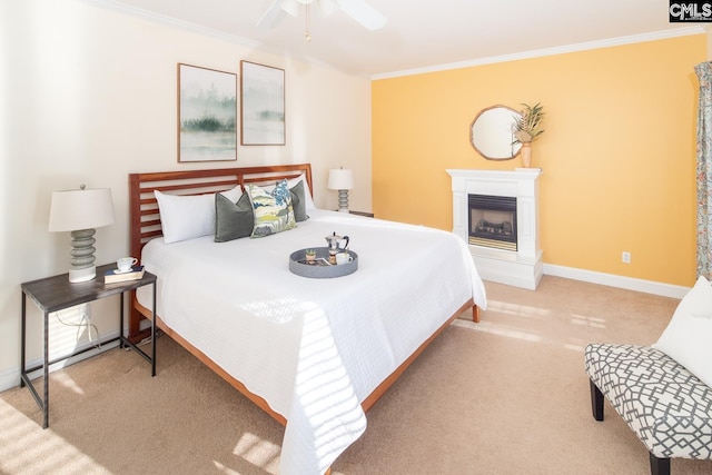 carpeted bedroom featuring ceiling fan and ornamental molding