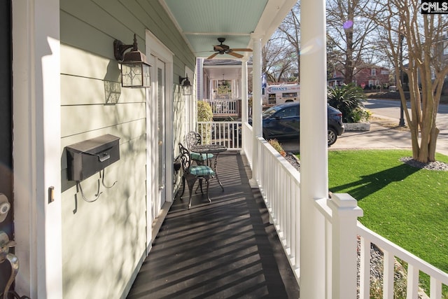 balcony with ceiling fan and a porch