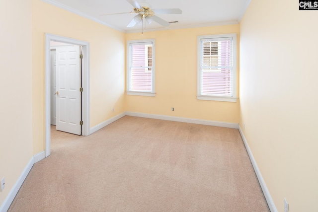 carpeted empty room featuring ceiling fan and ornamental molding