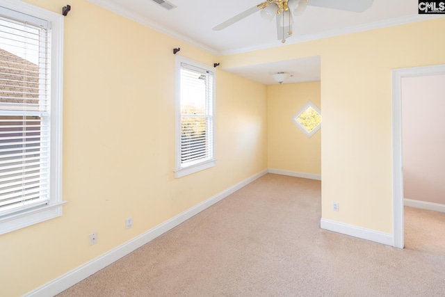 unfurnished room featuring ceiling fan, light colored carpet, and ornamental molding