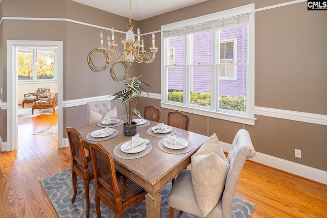 dining area featuring a notable chandelier and hardwood / wood-style floors