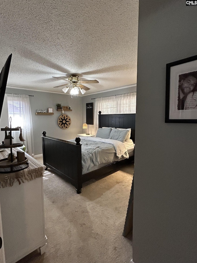 carpeted bedroom featuring crown molding, a textured ceiling, and ceiling fan