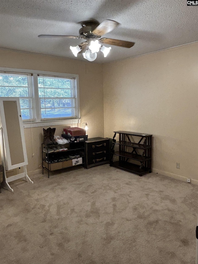 living area featuring light carpet, a textured ceiling, and ceiling fan