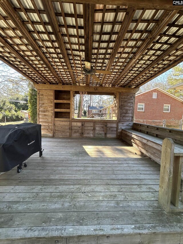 wooden deck with ceiling fan and grilling area