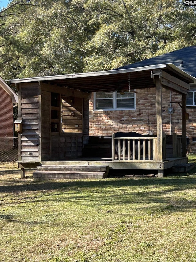 back of property featuring a lawn