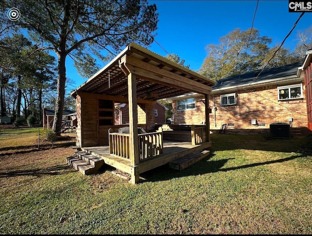 view of yard with central AC unit and a deck