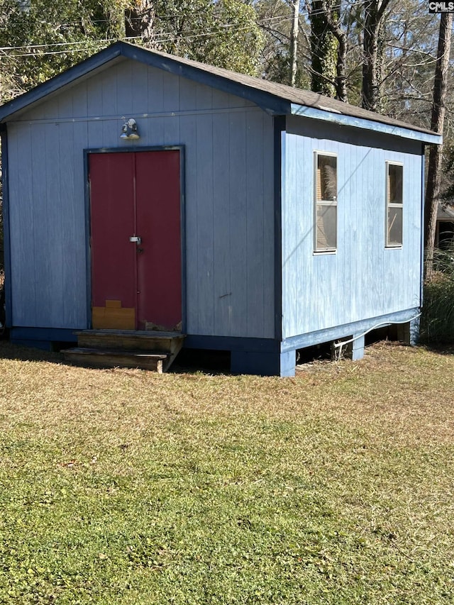 view of outbuilding featuring a yard