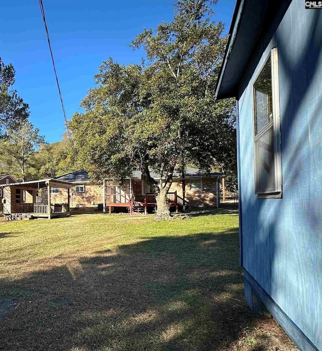 view of yard with a wooden deck