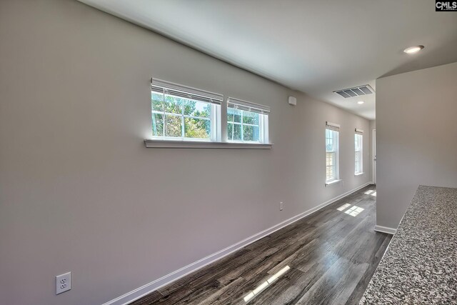 empty room featuring dark wood-type flooring