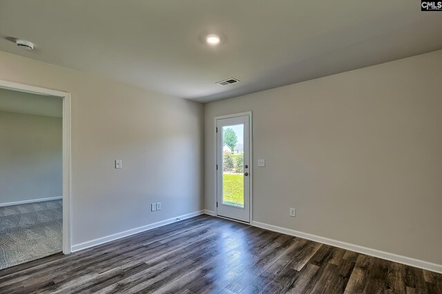 unfurnished room with dark hardwood / wood-style flooring